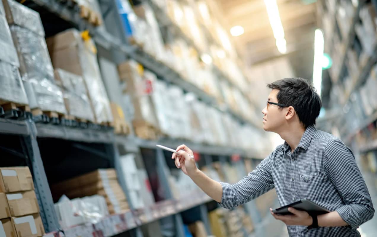 man reviewing inventory in a warehouse