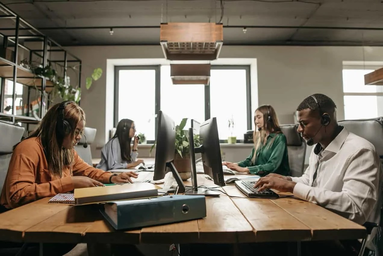 Group workspace with four workstations that is setup for client/customer calls.